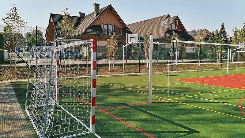Outdoor multisport field with goals and volleyball posts